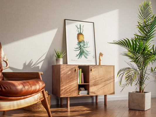Sunny room with a mid-century modern style. A wooden cabinet displays a reverse pineapple print for pleasure-positive subtle symbol. Books, plants and a leather chair add warmth.