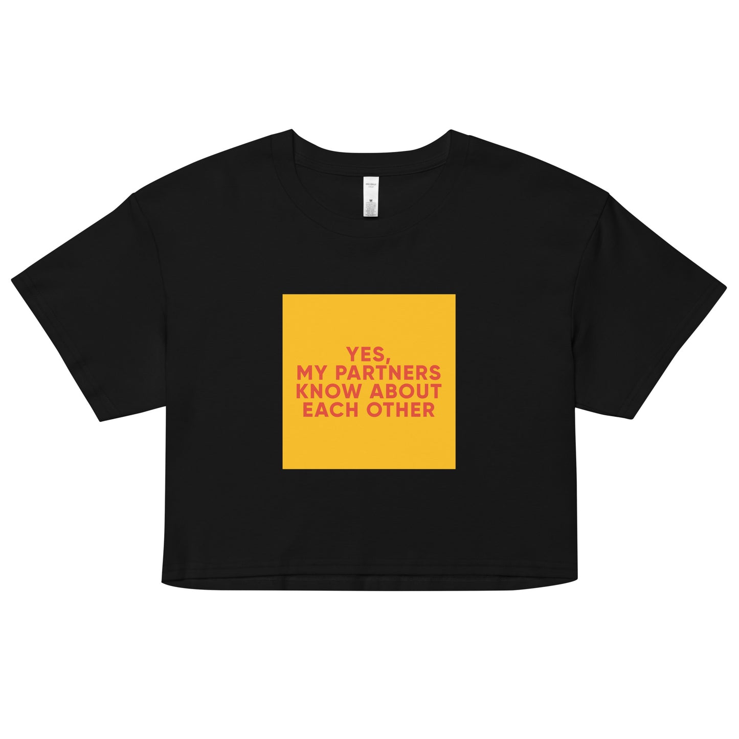 Black cropped tee with bold orange-red text reading “Yes, My Partners Know About Each Other,” cheeky ENM-affirming statement top for open-relationship style.