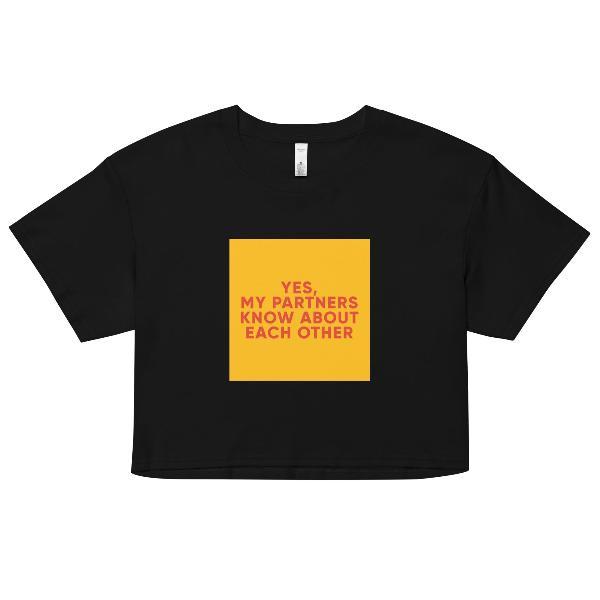 Black cropped tee with bold orange-red text reading “Yes, My Partners Know About Each Other,” cheeky ENM-affirming statement top for open-relationship style.