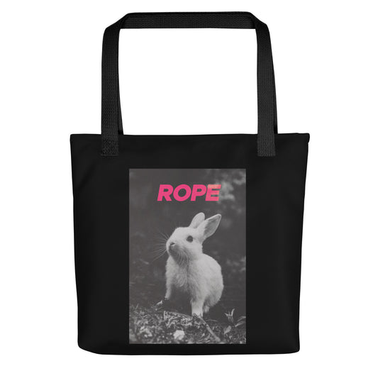 Black cotton tote bag with bold pink “ROPE” text and grayscale bunny illustration – playful, minimalist nod to alternative expression and rope art.