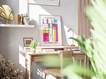 Modern queer wall art featuring colorful pansexual pride flag poster in modernist art style on a desk in a sunlit office with a laptop, notebook, and coffee, creating a modern, creative vibe.