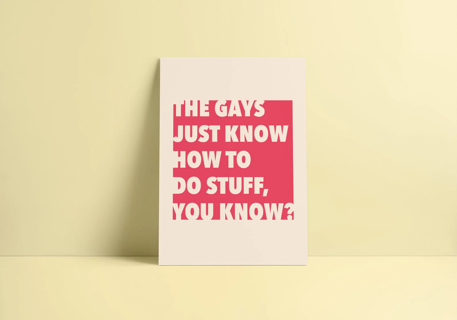 A minimalist decor with a digital download poster of The White Lotus queer quote in red.