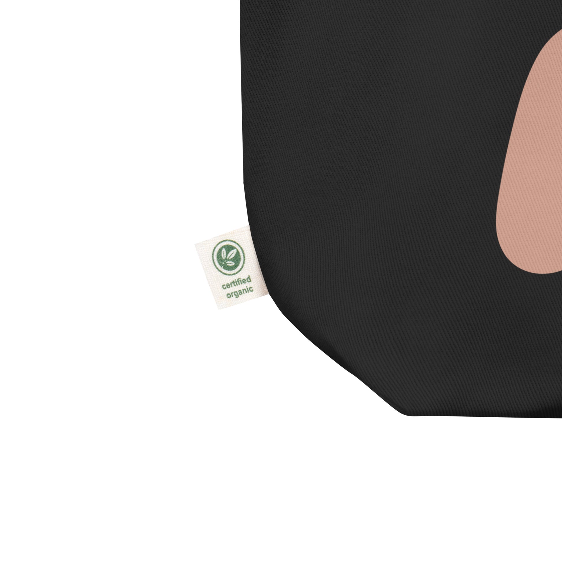 Close-up of bisexual pride design on black tote bag with certified organic label