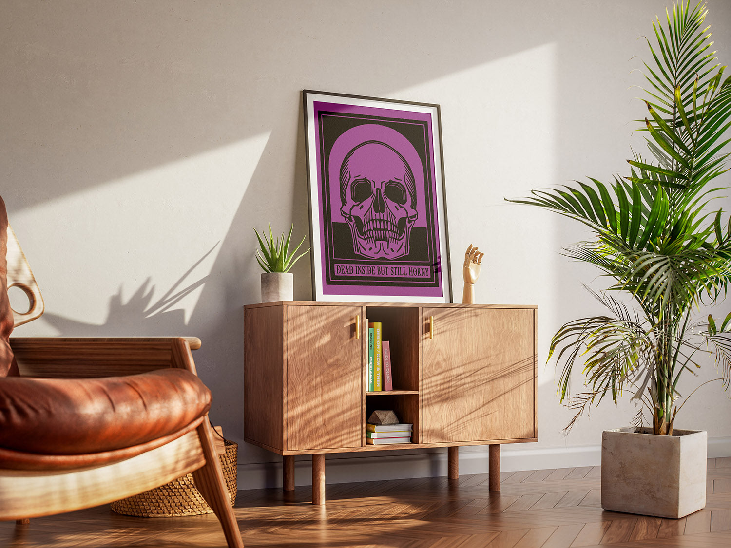 A cool living room with a framed vintage colorful and sarcastic skull poster. A wooden armchair, a cabinet and houseplants create a warm, inviting atmosphere.