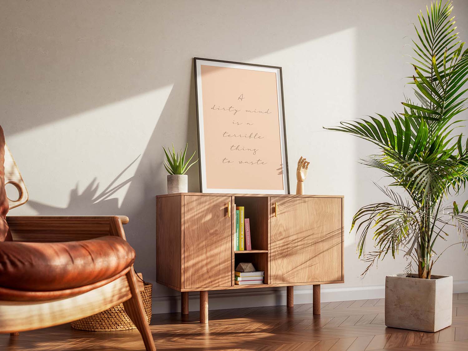 A cool living room with a framed cheeky quote poster celebrating sexual positivity. A wooden armchair, a cabinet and houseplants create a warm, inviting atmosphere.