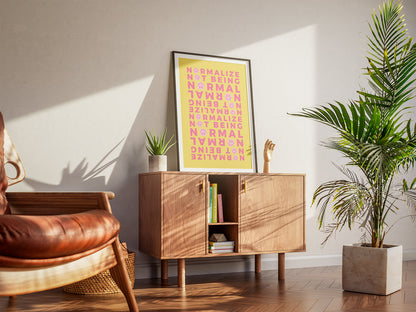 A cool living room with a framed Neurodivergent Affirmation Poster. A wooden armchair, a cabinet and houseplants create a warm, inviting atmosphere.