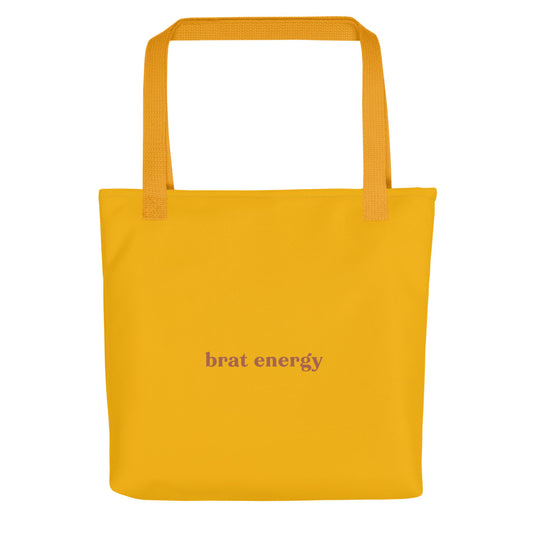 Mustard yellow eco tote bag with terracotta red “Brat Energy” text – playful accessory for flirty mischief, bold self-expression and confident daily wear