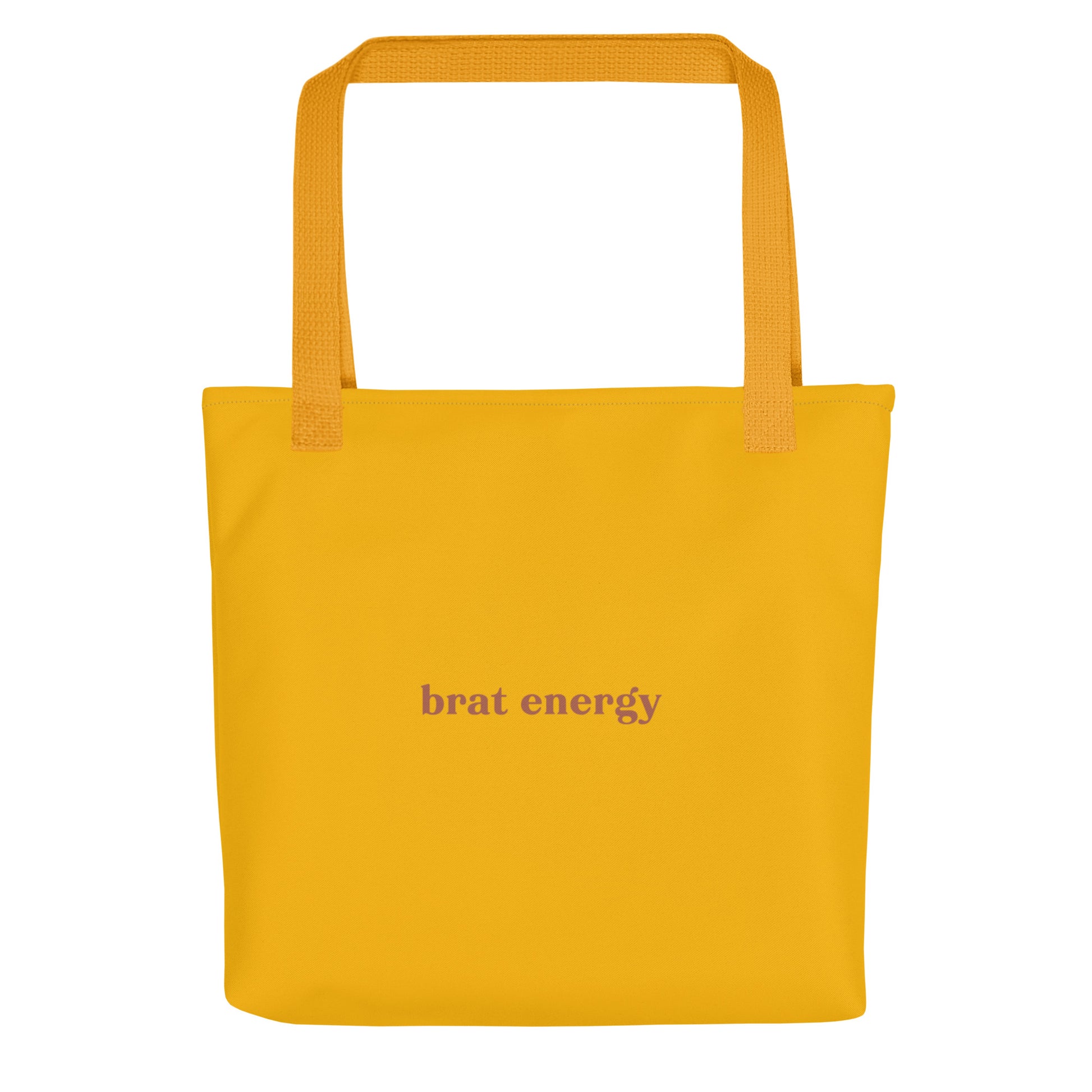 Mustard yellow eco tote bag with terracotta red “Brat Energy” text – playful accessory for flirty mischief, bold self-expression and confident daily wear.