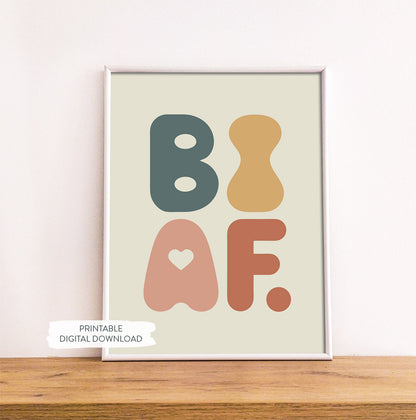 Bisexuality pride printable poster ‘BI AF’ shown in white frame on wood shelf