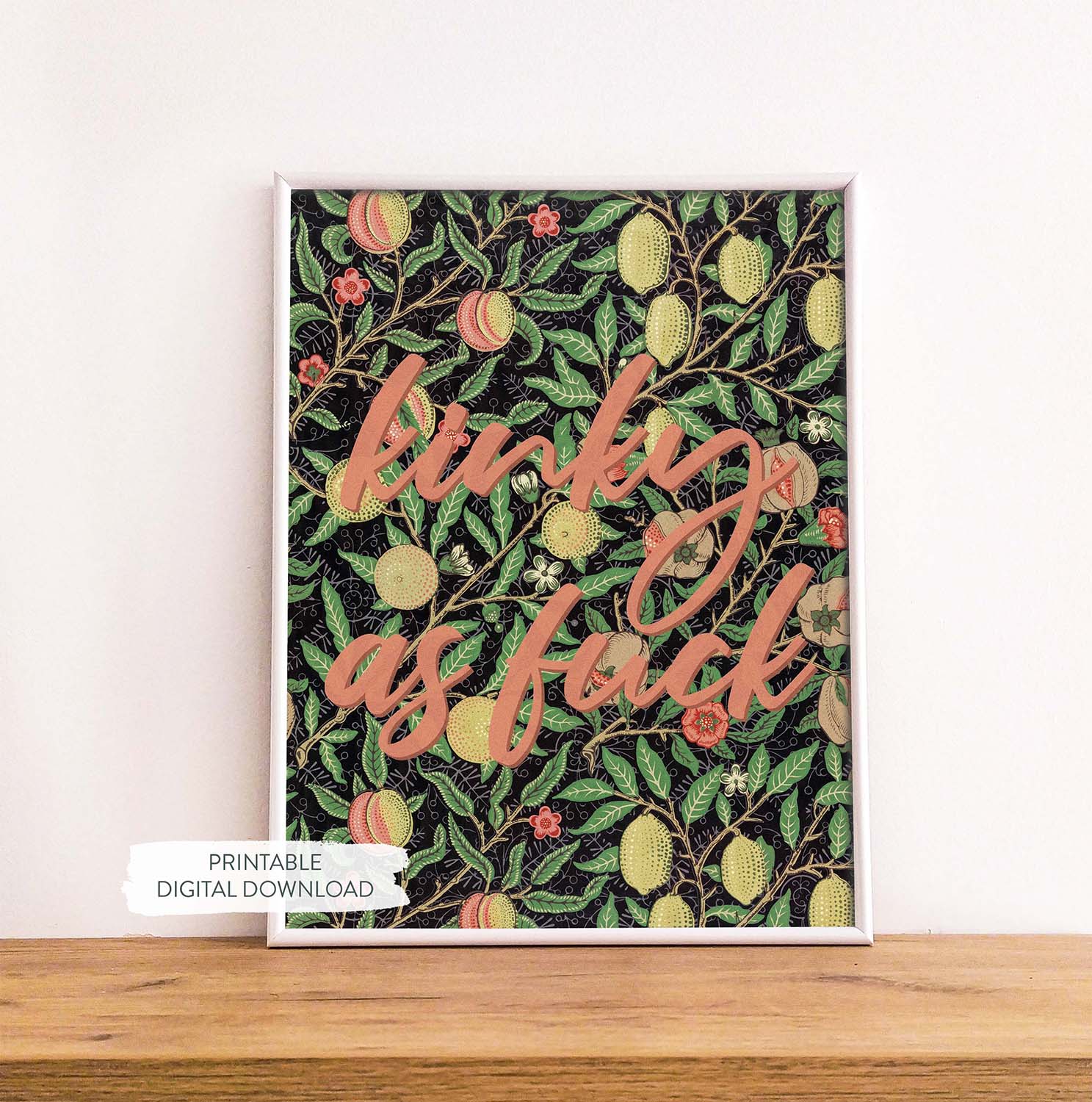 Colorful vintage inspired printable poster with pleasure-positive quote shown in white frame on wood shelf.