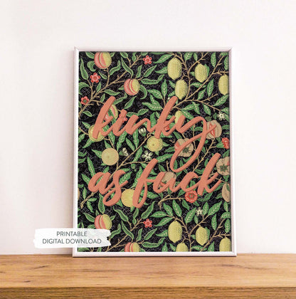 Colorful vintage inspired printable poster with pleasure-positive quote shown in white frame on wood shelf.