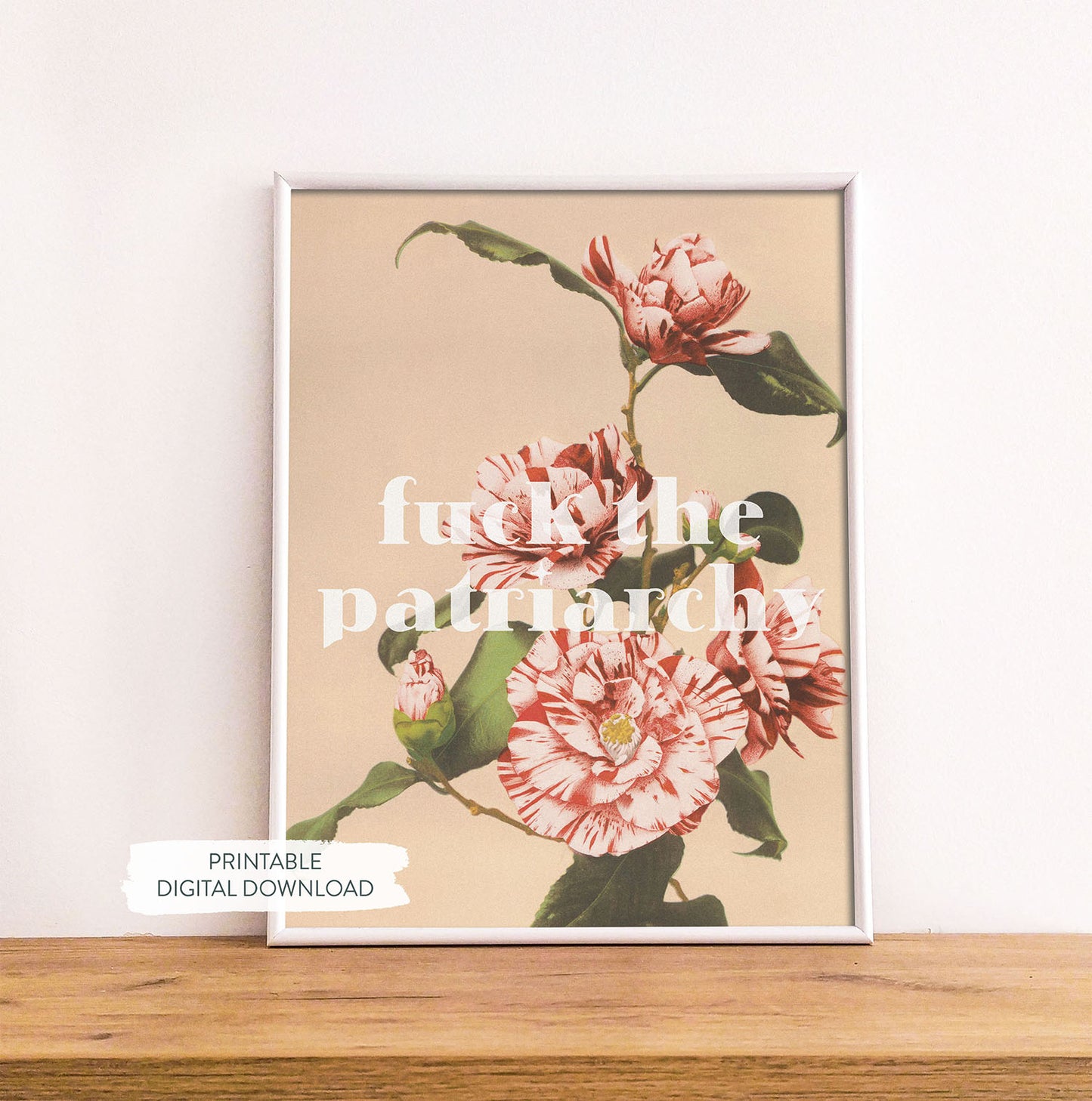 Feminist printable poster ‘Fck the Patriarchy’ shown in white frame on wood shelf