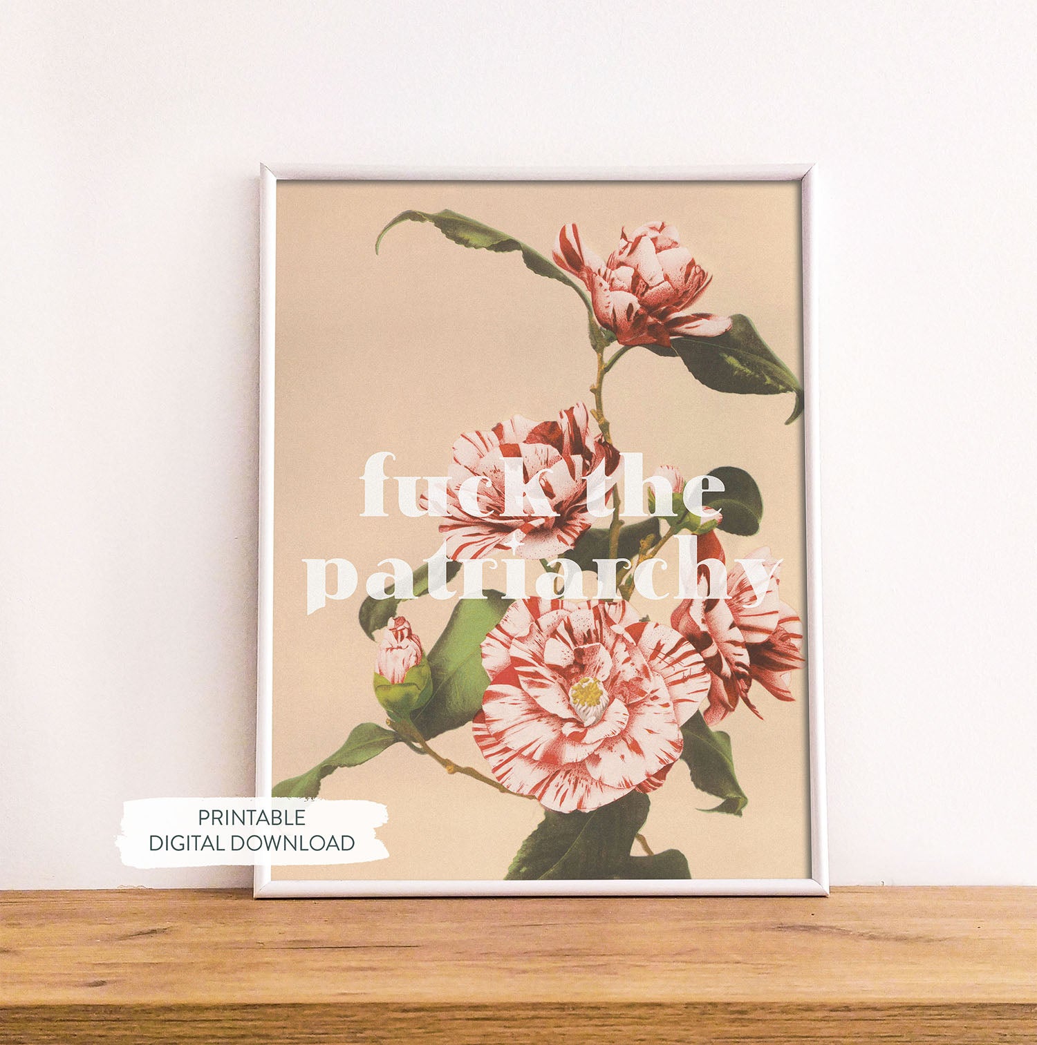 Feminist printable poster ‘Fck the Patriarchy’ shown in white frame on wood shelf