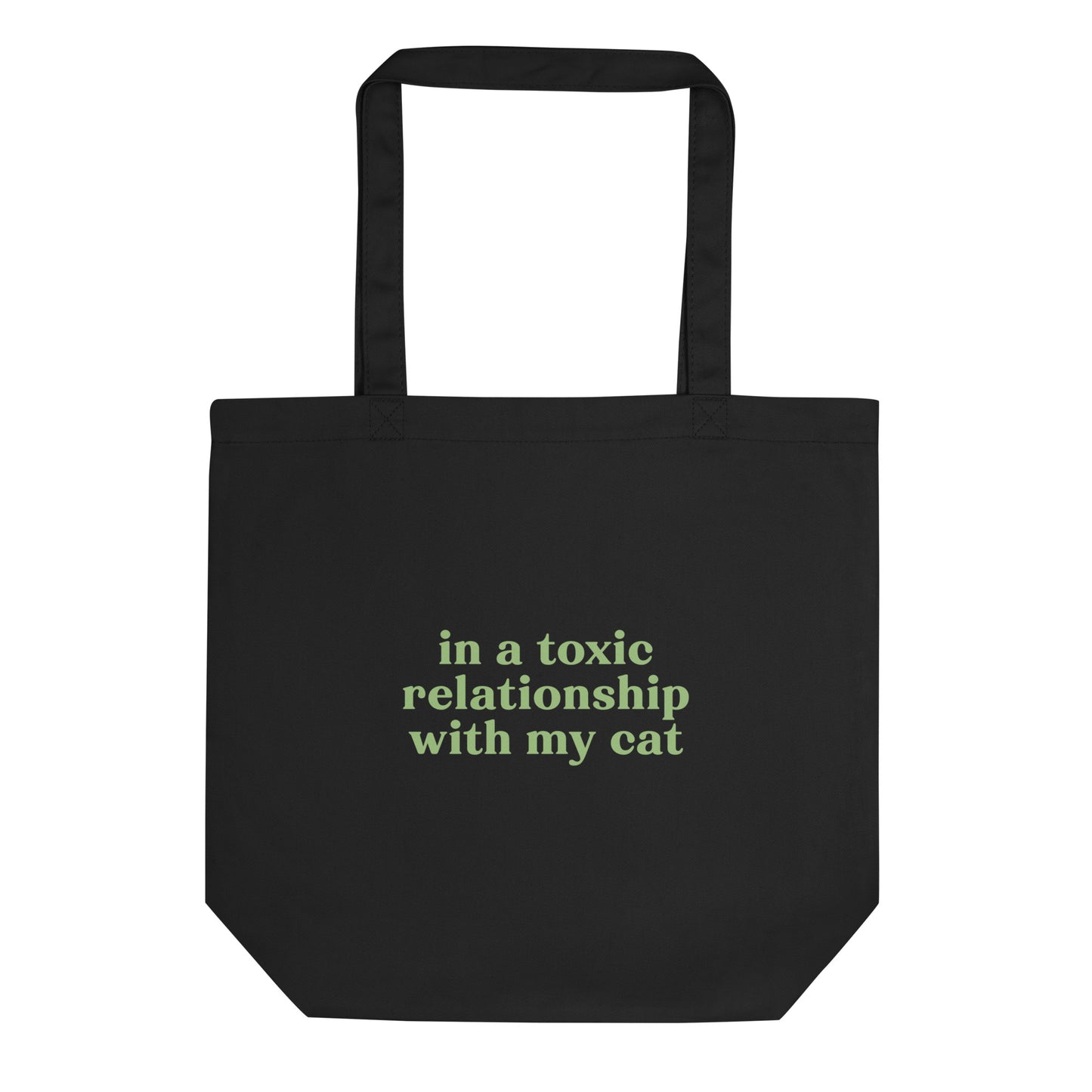 Black eco tote bag with green text saying 'In a Toxic Relationship with My Cat' for cat lovers tired of dating.