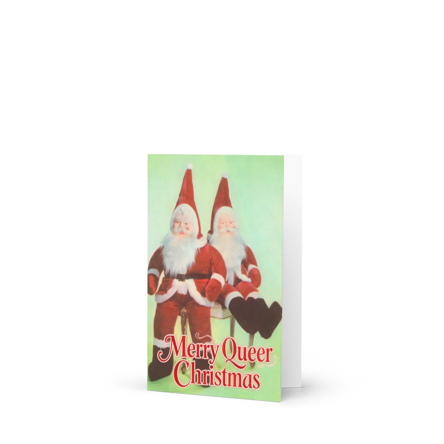 Vintage-style greeting card featuring two plush Santa dolls against a teal background with text reading “Merry Queer Christmas” for funny LGBTQ+ affirmation holiday card.