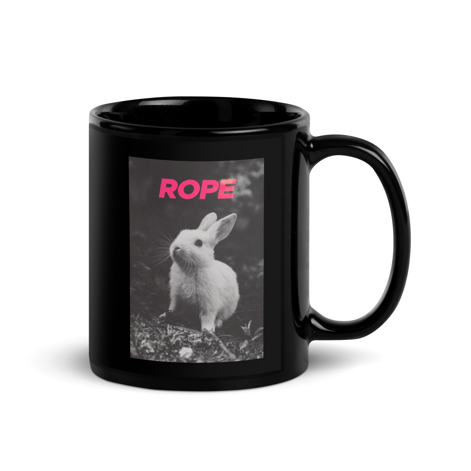 Glossy black ceramic mug with bold pink ROPE text above a black-and-white bunny print – playful rope art gift or desk bold accessory