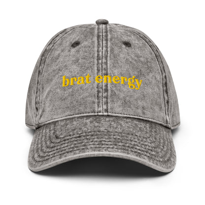 Charcoal grey vintage-style hat with golden stitched “Brat Energy” – subtle statement piece for pleasure-positivity and boundary-pushing charm
