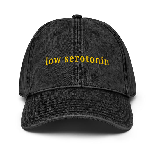 Cotton cap with embroidered text “Low Serotonin” in bold yellow  – neurodivergent sarcastic style hat for daily existential dread.