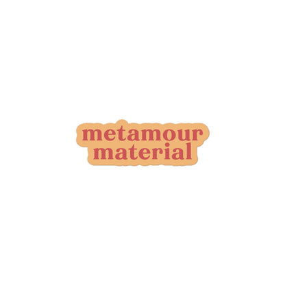 Vinyl sticker with light peach background and soft red text reading “metamour material,” supportive polyam vinyl decal for laptops and gifts.