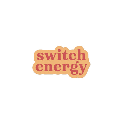 Vinyl sticker with light peach background and soft red text reading “switch energy,” versatile play-positive decal for laptops, bottles and journals.