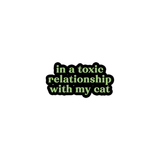Vinyl sticker with green text saying “in a toxic relationship with my cat” for cat lovers with sarcastic dating dread.