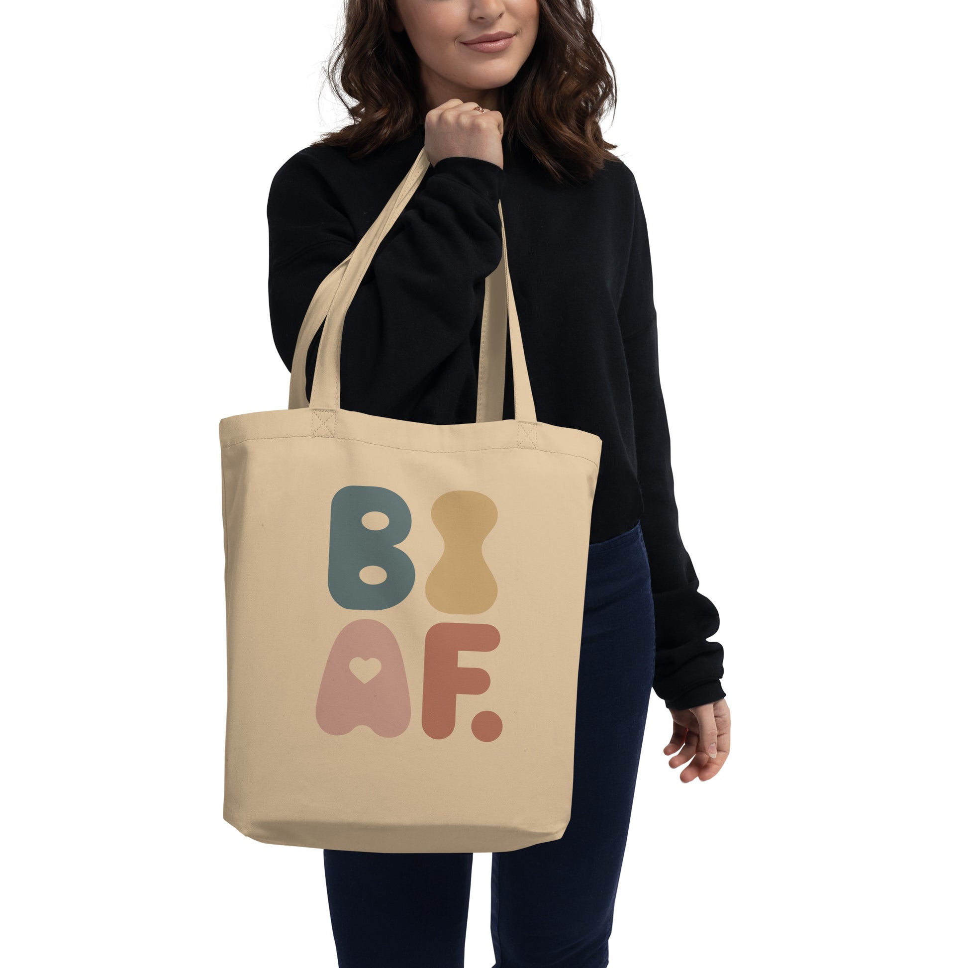 Woman wearing bisexual symbol beige tote bag featuring colorful retro inspired artwork for queer affirmation