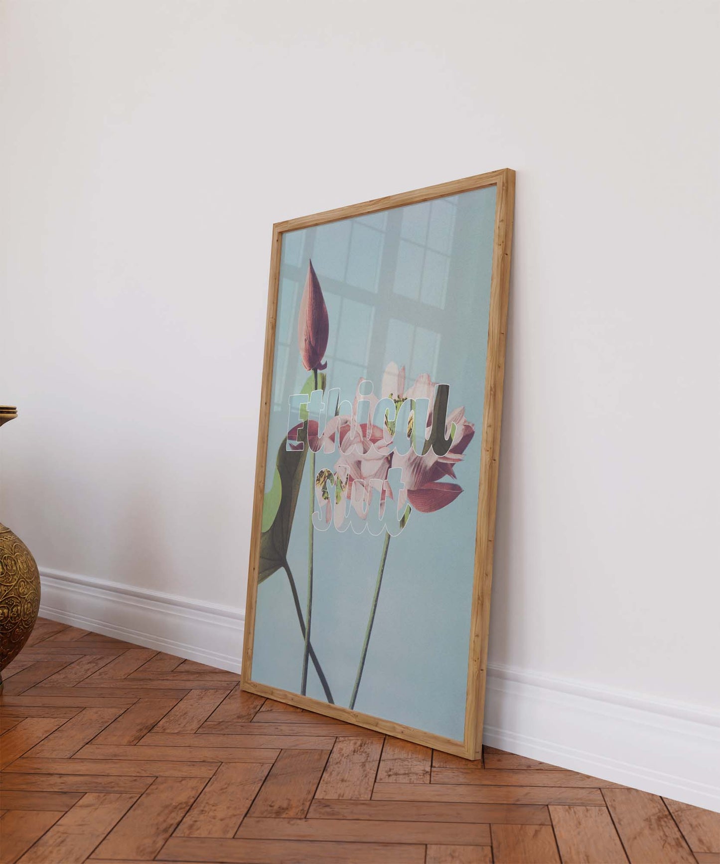 Framed vibrant sex-positive poster with "Ethical slt" printed on vintage illustration leans against a colorful wall on a wooden floor.